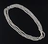 A triple strand freshwater? pearl necklace with white gold and diamond cluster set clasp, 68cm.                                        