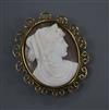 A 9ct mounted oval cameo brooch, carved with the bust of a lady to sinister, with scrolling border, 50mm.                              