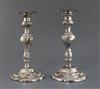 A pair of late George II embossed silver candlesticks, by William Tuite, weighted.                                                     