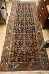 A Caucasian black ground hall carpet 294 x 105cm                                                                                       