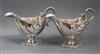 A pair of George III silver pedestal sauceboats, London, 1763?, (repairs), gross 27.5 oz.                                              