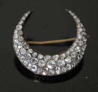 A 19th century French gold and foil backed graduated rose cut diamond set crescent brooch,                                             