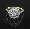 An 18ct gold, platinum and illusion set diamond nine-stone cluster ring, size O.                                                       