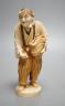 A Japanese ivory figure of a peasant farmer, Taisho/early Showa period, signed to a lacquer tablet - 17cm tall                                                                                                              