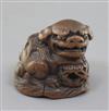 A Japanese wood netsuke of a shishi, seated on a rock, 19th century, w. 3.6cm                                                          