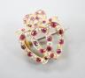 An early 20th century yellow metal, ruby and diamond set twin hearts brooch, with ribbon bow crest, 18mm, gross 2.4 grams.                                                                                                  