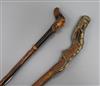 Two carved handled walking sticks longest 92cm                                                                                         