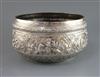 A Burmese silver rice bowl of large proportions with all round embossed scenes of figures, animals, scrolls and flowers,               