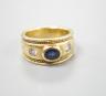 A modern yellow metal and collet set sapphire and diamond three stone ring, signed Charles Greig, size M, gross weight 11.5 grams.                                                                                          