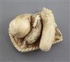 A Japanese ivory netsuke of vegetables on a woven tray, Meiji period, signed Komei, l. 3.7cm                                           