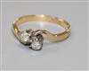 An 18ct gold and two stone diamond crossover ring, size M.                                                                             