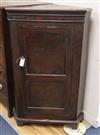 A George III oak and mahogany corner cabinet H.114cm                                                                                   