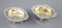 A pair of George III cast silver oval table salts by Paul Storr,                                                                       