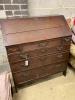 A George III oak bureau, width 94cm, depth 49cm, height 105cm                                                                                                                                                               