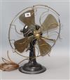 A 1920/30s fan with brass blades and ornate front height 40cm                                                                          