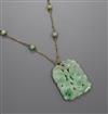 A 14k yellow metal and carved jadeite set pendant necklace, pendant 40mm.                                                              