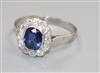 A mid 20th century white metal, synthetic sapphire? and diamond cluster dress ring, size O/P.                                          