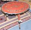 A 19th century Swiss painted folding table, 75 cm long, 56 cm deep, 62 cm pine, the underside with carved heads and painted religious scene                                                                                 