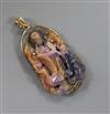 A gold mounted corundum pendant carved with the figure of Guan Yin, 56mm.                                                              