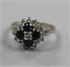 An 18ct white gold, sapphire and diamond cluster dress ring, size N.                                                                   