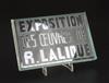 An inter-war period 'Exposition Des Oeuvres De R. Lalique' exhibition plaque, introduced in 1928, 10 x 15cm.                           