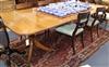 A William Tillman George III style two-pillar dining table having two additional leaves L 253cm                                        