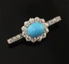 A gold and platinum, oval turquoise and diamond set bar brooch, 38mm.                                                                  