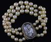 A triple strand cultured bracelet, now with a Regency gold mounted oval panel mourning clasp,                                          