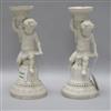 A pair of Victorian Minton bisque porcelain putti candlesticks H.24cm.                                                                 