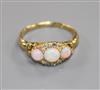 An Edwardian 18ct gold, white opal and diamond cluster ring, size M.                                                                   