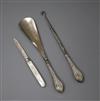 An early 20th century silver handled shoe horn and button hook and a silver mother of pearl fruit knife.                               