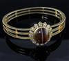 A mid 20th century Victorian style pierced gold, diamond and cabochon banded agate set hinged bracelet.                                