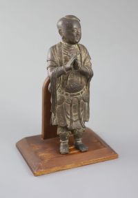 A Chinese bronze figure of Shancai Tongzi, late Ming dynasty, 25.5cm high, repairs, Provenance - A. T. Arber-Cooke                     