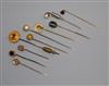 Ten assorted yellow metal and gem set stick pins.                                                                                      