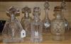 A pair of 1930's shaped square-section engraved glass decanters with silver collars and pyramid stoppers and four other decanters,     