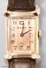 A gentleman's 1930's 14k gold filled Bulova manual wind rectangular dial wrist watch, with subsidiary seconds, on later leather strap.                                                                                      