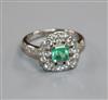 An Art Deco style white gold, emerald and diamond cluster ring, size M.                                                                