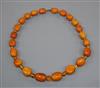 A single strand graduated amber bead necklace and loose beads, gross 96 grams, 54cm.                                                   