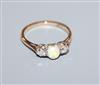 An '18ct and plat', white opal and diamond three stone ring, size K/L.                                                                 