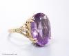 A 9ct gold and oval cut amethyst set dress ring, size H                                                                                                                                                                     