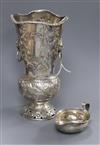 An Edwardian embossed silver vase, D & J Welby, London, 1907 and a white metal pap boat.                                               