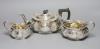 An Edwardian embossed silver three piece tea set, Hammond, Creake & Co, Sheffield, 1903                                                                                                                                     