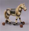 An early 20th century toy horse on wheels height 30cm                                                                                  