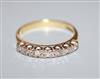 An 18ct gold and seven stone diamond half hoop ring, size N.                                                                           