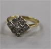 A yellow metal and diamond cluster ring, set with round and princess cut stones, size L.                                               