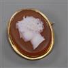 A yellow metal mounted hardstone oval cameo brooch, carved with head of a lady to dexter, 29mm.                                        