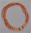 A triple strand coral and cultured pearl bead necklace with 9ct gold clasp, 46cm.                                                      