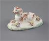 A rare Derby figure of a recumbent spaniel, c.1758-60, l. 9cm, several flowers restored                                                