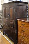 An early 18th century oak wardrobe / cupboard enclosed by fielded panels W.136cm                                                       