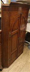 A George III oak and mahogany corner hanging cabinet W.90cm                                                                            